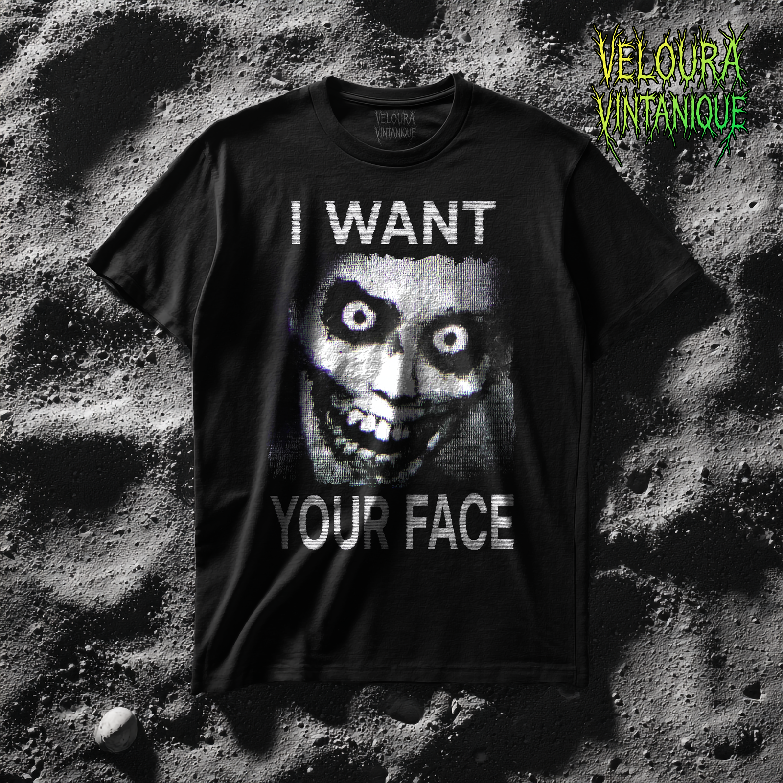 This t-shirt features a disturbing black-and-white analog horror style design with heavy VHS static texture, showing a wide-eyed, nightmarish distorted face with exaggerated round eyes, dark shadowed sockets, and a twisted grin full of uneven teeth, placed in the center of the shirt, while the bold glitch-like text “I WANT” is written above the face and “YOUR FACE” is written below, creating a haunting and unsettling creepycore aesthetic.