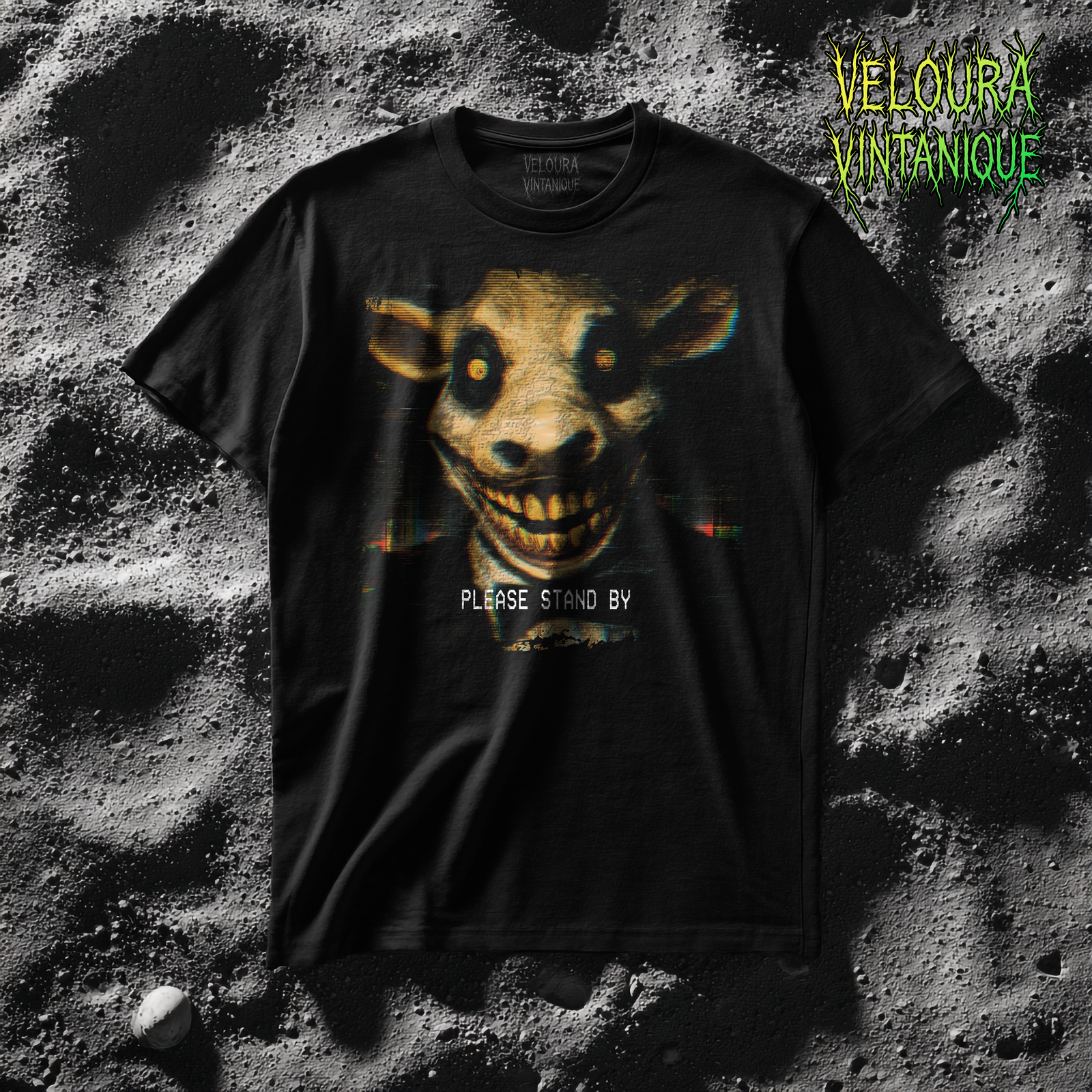 Analog horror t-shirt featuring a design of a distorted cow wearing a suit. Scary human like creature with mutilated face staring directly at you. Underneath the design it reads "PLEASE STAND BY".
