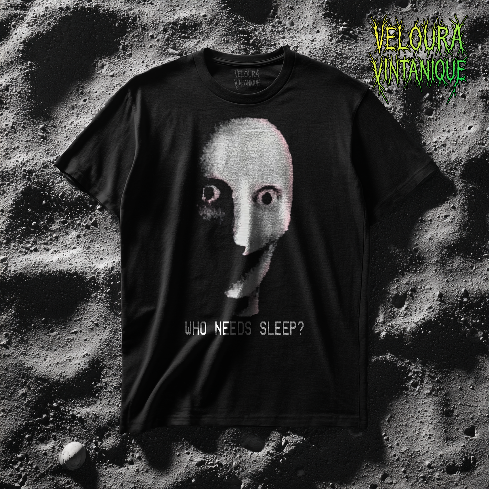 This T-shirt features an analog horror inspired design with a distorted humanoid face printed in a grainy, VHS-style texture. The pale bald head looks mask-like, with unnaturally wide eyes staring directly forward and a stretched grin that feels more inhuman than human. The left side of the face is swallowed in shadow while faint pink tones outline the right, giving it an eerie asymmetry. The entire image has a degraded, low-resolution look, as if it were captured from corrupted surveillance footage. Beneath the face, in a glitchy retro computer font, the words “WHO NEEDS SLEEP?” are displayed, adding a mix of dark humor and horror. The overall effect is unsettling, cryptic, and perfectly captures the disturbing analog horror aesthetic.