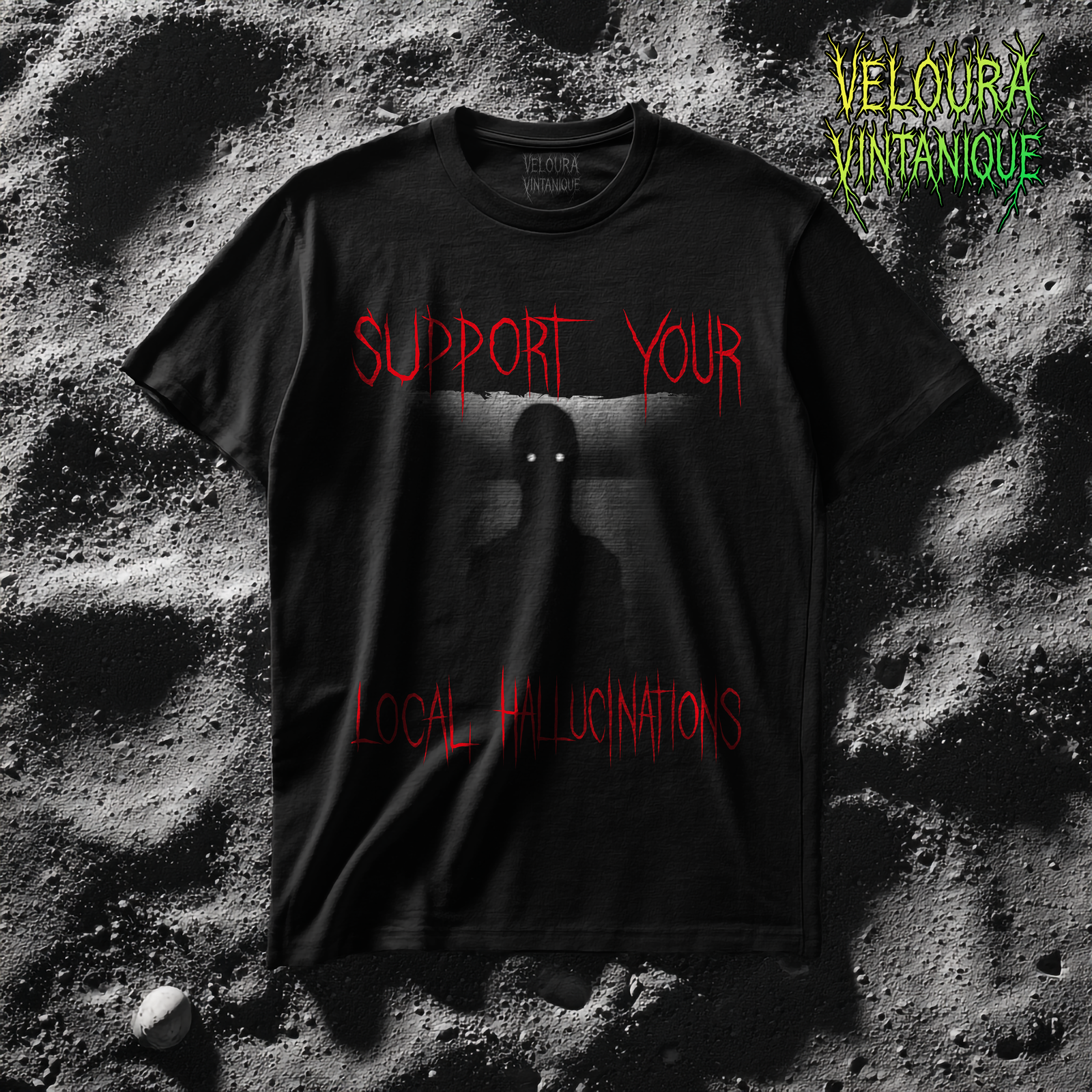 This horror T-shirt features a haunting shadow figure with glowing white eyes emerging from a grainy, distorted background. The words “SUPPORT YOUR LOCAL HALLUCINATIONS” appear in dripping red lettering, adding a chilling analog-horror vibe. The design mixes VHS static, dark textures and eerie minimalism, creating a creepy atmospheric graphic perfect for horror lovers, glitchcore fans and those who enjoy unsettling surreal artwork.