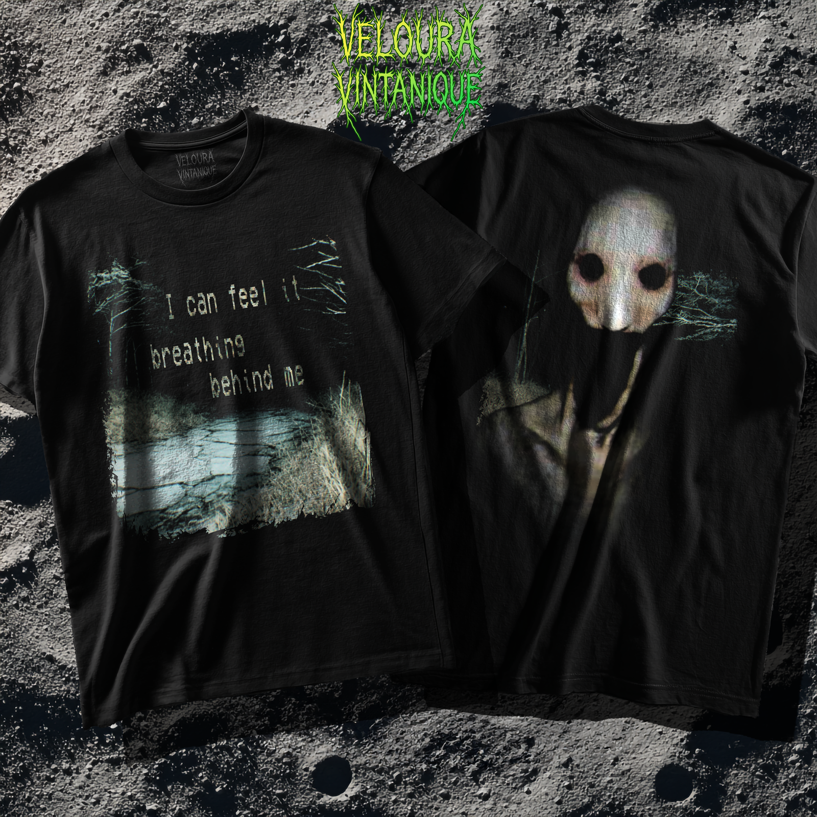 The T-shirt design features a dark, distressed analog-horror aesthetic printed on a shirt. On the left half, a grainy, desaturated forest scene is shown with dead grass and a cracked, icy ground. Over the landscape, glitchy white text reads “I can feel it breathing behind me,” styled with a worn, typewriter-like font. Scratched textures, noise, and static effects surround the text and edges of the image, giving it a corrupted VHS-tape appearance. On the right half of the shirt, there is a haunting pale creature with hollow black eyes and a mask-like face, emerging from the darkness. Its elongated form blends into the black background, with faint teal tree-branch textures around it, enhancing the eerie atmosphere. The overall design is unsettling, cinematic, and intentionally degraded to evoke a lost-footage horror vibe.