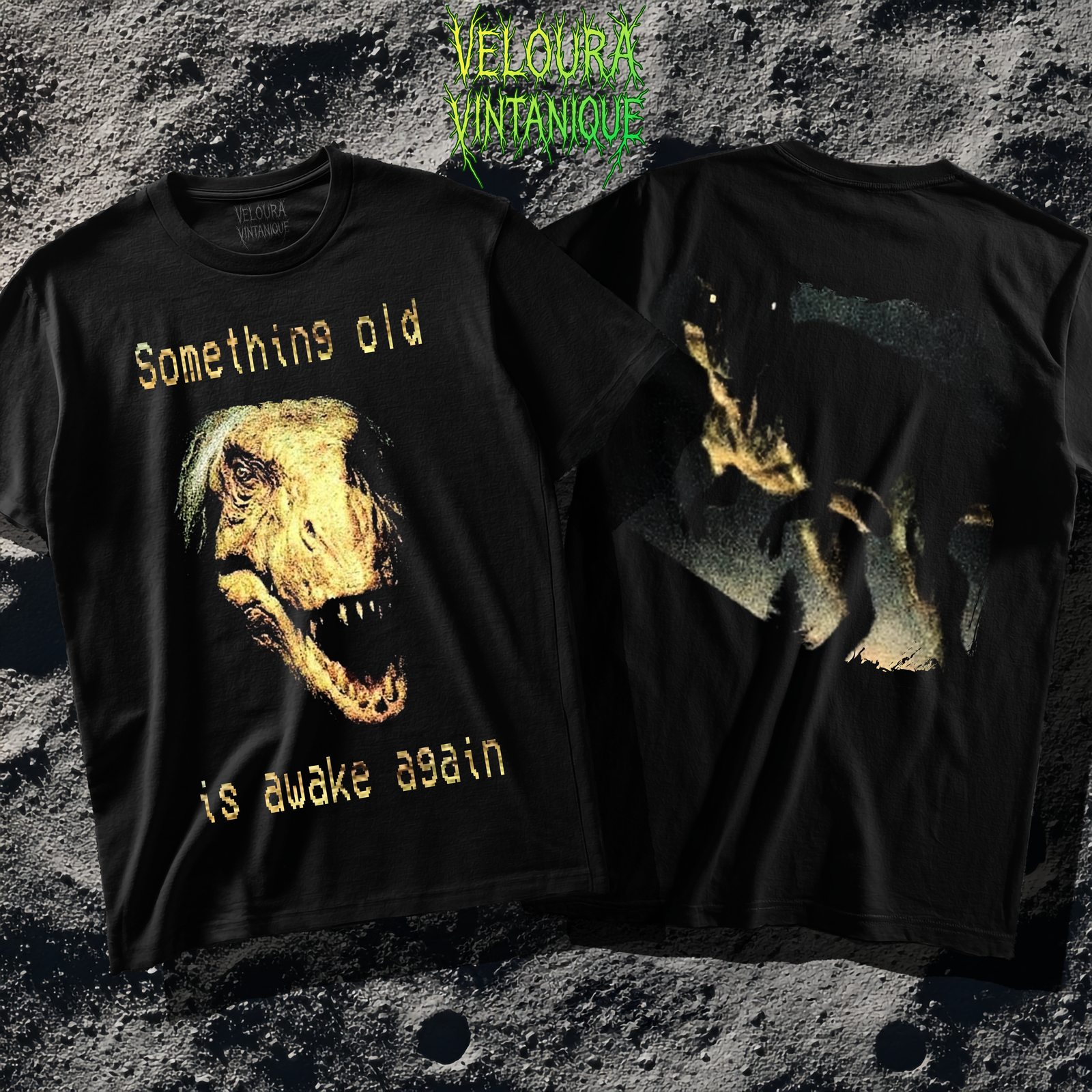 The shirt features a disturbing analog horror–style design depicting a decayed, human-eyed dinosaur with leathery yellowish skin and sharp teeth, its mouth slightly open as if snarling. Above the creature’s head, in a pixelated yellow horror font, reads the phrase “Something old,” and below it, continuing the same text style, “is awake again.” The image has a grainy, VHS-like texture that enhances the eerie, vintage look. On the back of the shirt, a dark, low-lit scene shows the same monstrous dinosaur walking at night with glowing eyes, captured in a distorted, grainy aesthetic reminiscent of found-footage horror. The overall design combines prehistoric terror with analog horror visuals, creating a haunting, nostalgic nightmare effect.
