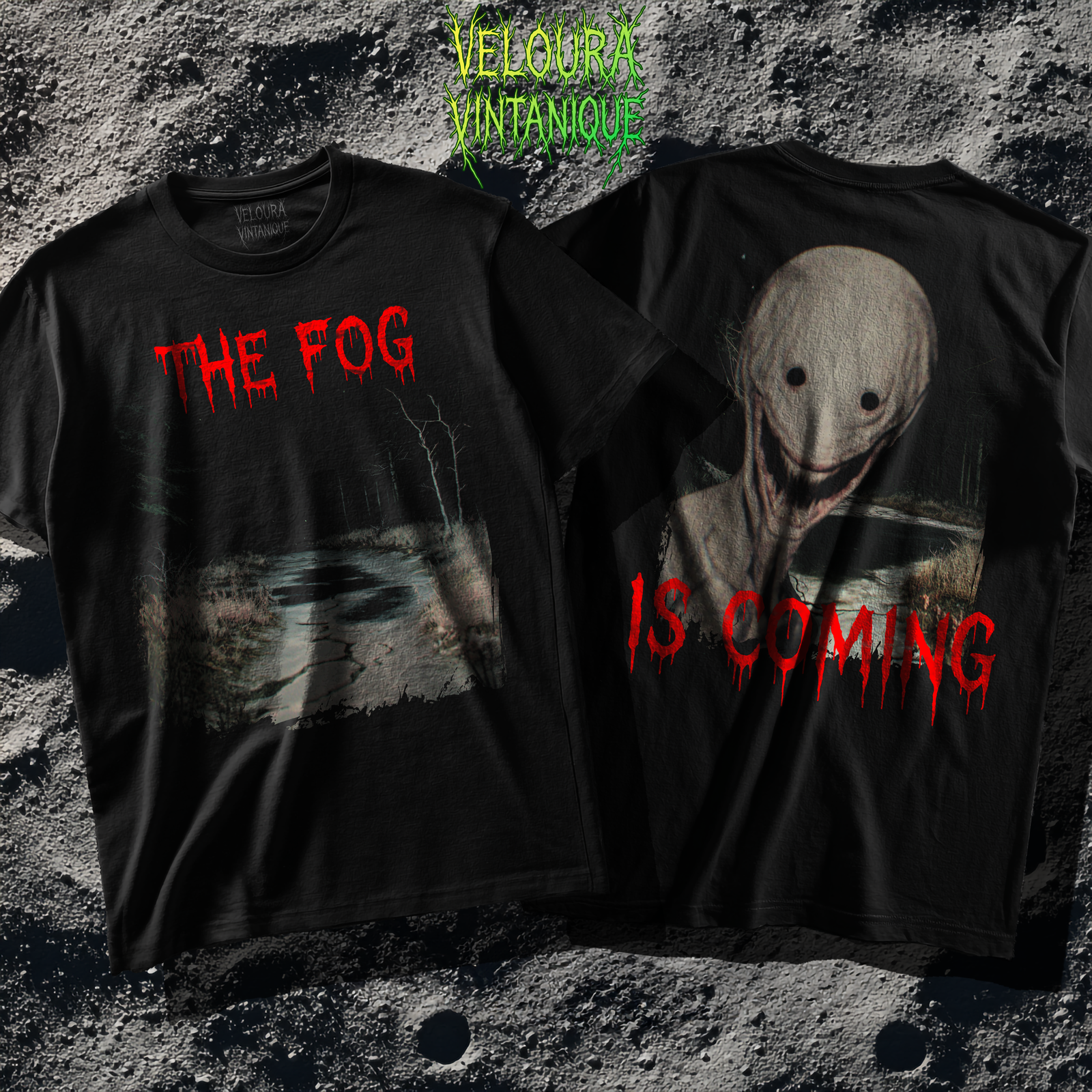 The shirt features a dark, desaturated forest path surrounded by dead trees and heavy shadows, creating a cold, abandoned atmosphere. Above the scene, dripping red text reads “THE FOG,” while on the opposite side a distorted, pale humanoid creature with hollow eyes and a wide, unnatural smile emerges from the misty background. Beneath it, the matching red text “IS COMING” completes the ominous analog-horror design.