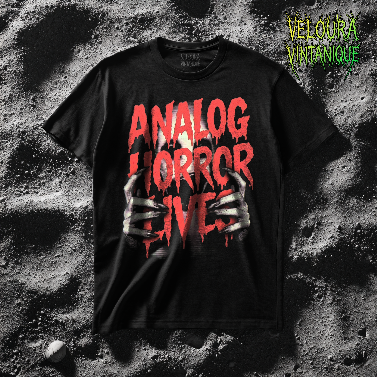 This T-shirt features a bold analog horror design with large, dripping red text reading “ANALOG HORROR LIVES,” inspired by VHS-era horror posters and underground creepypasta aesthetics. Behind the text, pale skeletal hands claw forward from the darkness, creating a layered illusion of something trying to escape the screen. The rough textures, glitch-like fading, and high-contrast colors give the artwork a raw, unsettling presence. Designed to feel intense and confrontational, this piece is made for fans of analog horror, dark internet lore, and disturbing visual storytelling.