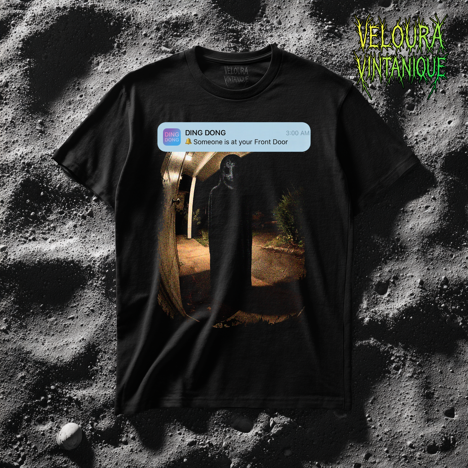 This horror T-shirt features a chilling doorbell-camera style scene captured at night, showing a dark human-like silhouette standing silently at the front door. Above the image is a realistic smartphone notification reading “DING DONG – Someone is at your Front Door – 3:00 AM,” instantly triggering unease and recognition. The grainy, low-light texture and distorted colors mimic real security footage, blending modern tech anxiety with analog horror aesthetics. Perfect for fans of creepy realism, liminal fear, and psychological horror visuals.