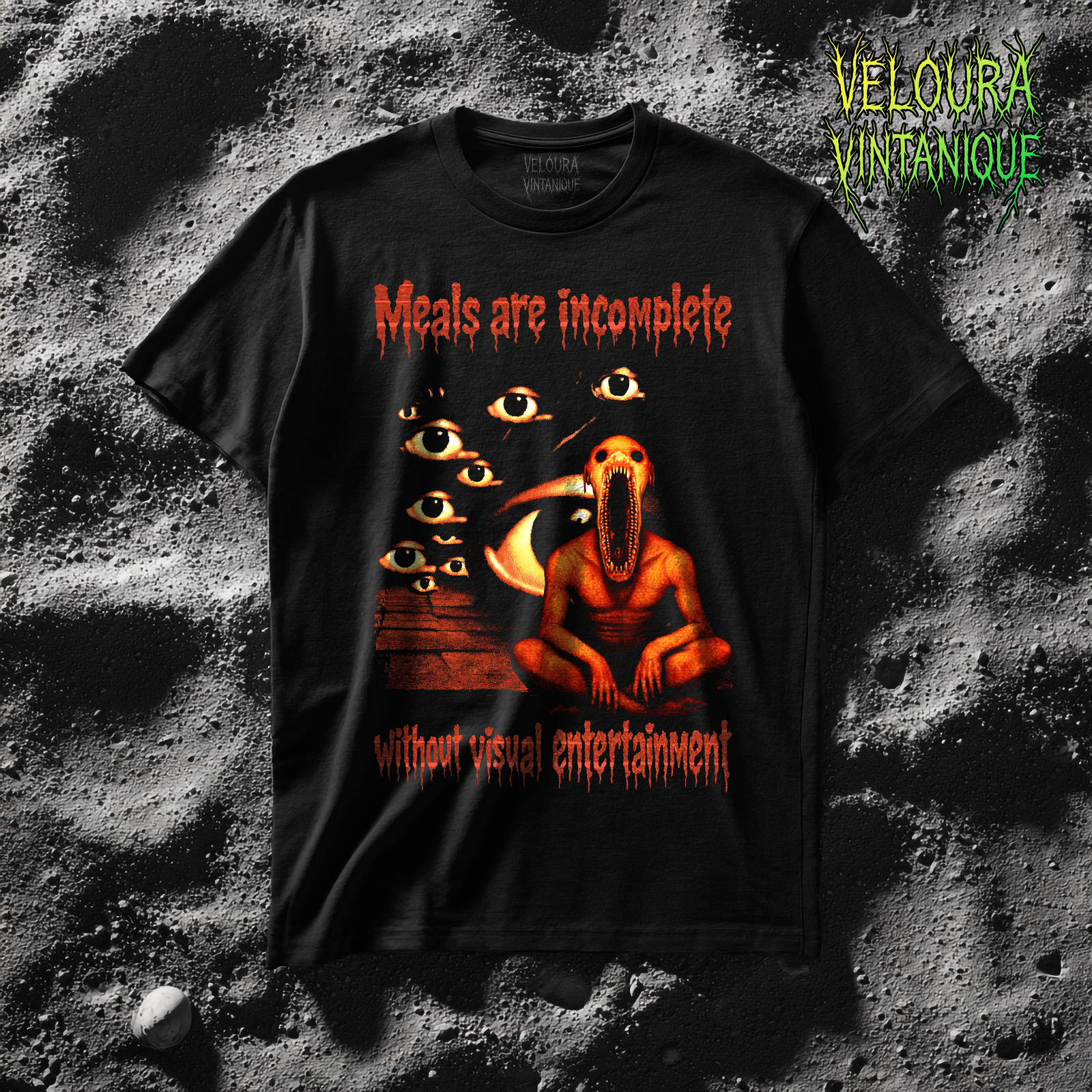 This unsettling T-shirt features a disturbing analog horror illustration paired with the phrase “Meals are incomplete without visual entertainment.” The design shows a grotesque humanoid creature seated beneath a crescent moon, surrounded by watching eyes that create a feeling of constant observation. The gritty textures, dark red tones, and surreal horror elements give the artwork a vintage analog nightmare aesthetic. Perfect for fans of creepy art, surreal horror, and statement graphic tees that provoke curiosity and discomfort in equal measure.