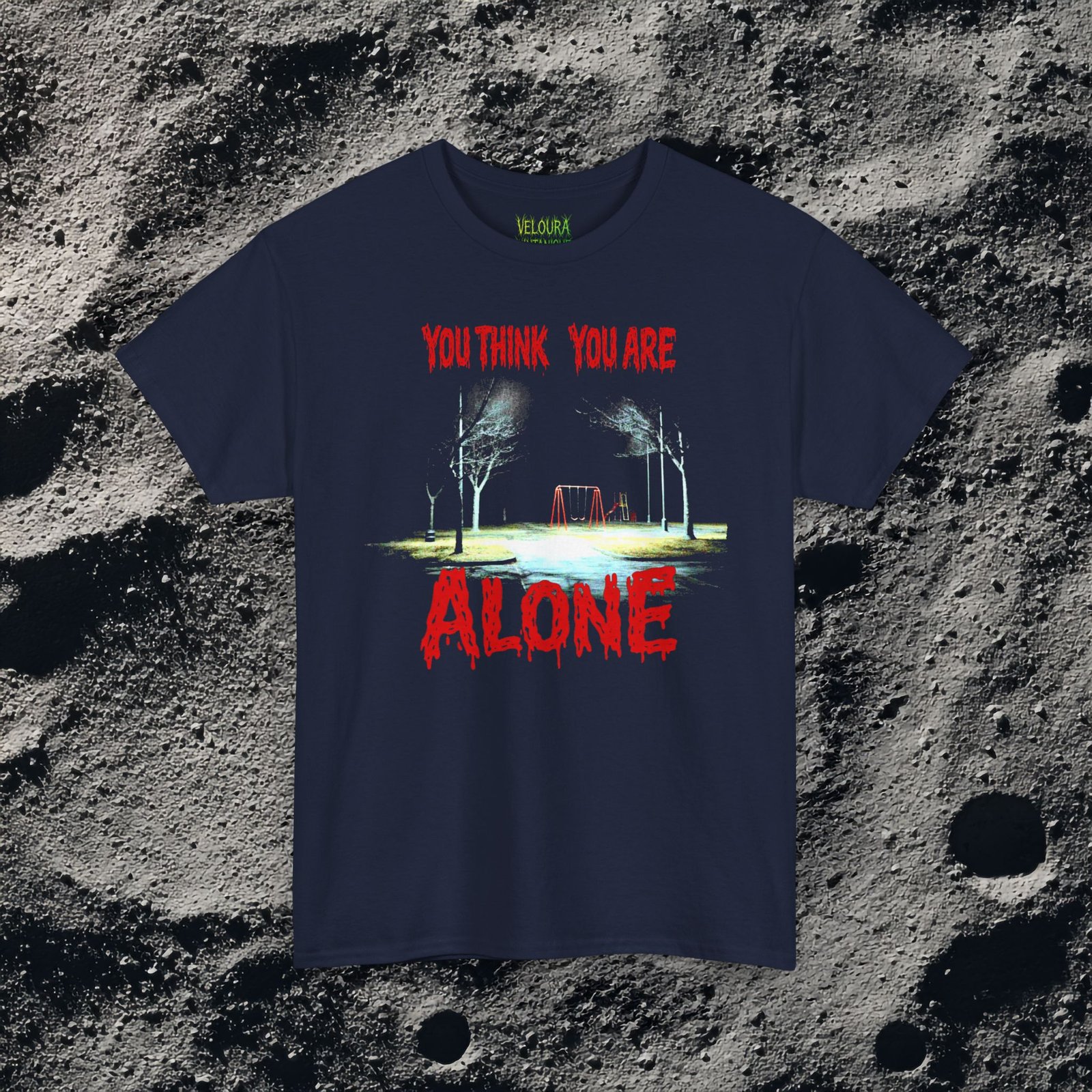 This unsettling double-sided design features a dark, rainy playground at night on the front with the text “You Think You Are Alone,” and a shadowy park path on the back with glowing eyes in the distance and the words “But the Corner of Your Eye Says Otherwise.” The grainy, low-light imagery and dripping red horror typography create a strong analog horror and liminal space atmosphere. Perfect for fans of creepy quotes, psychological horror, and eerie visual storytelling.