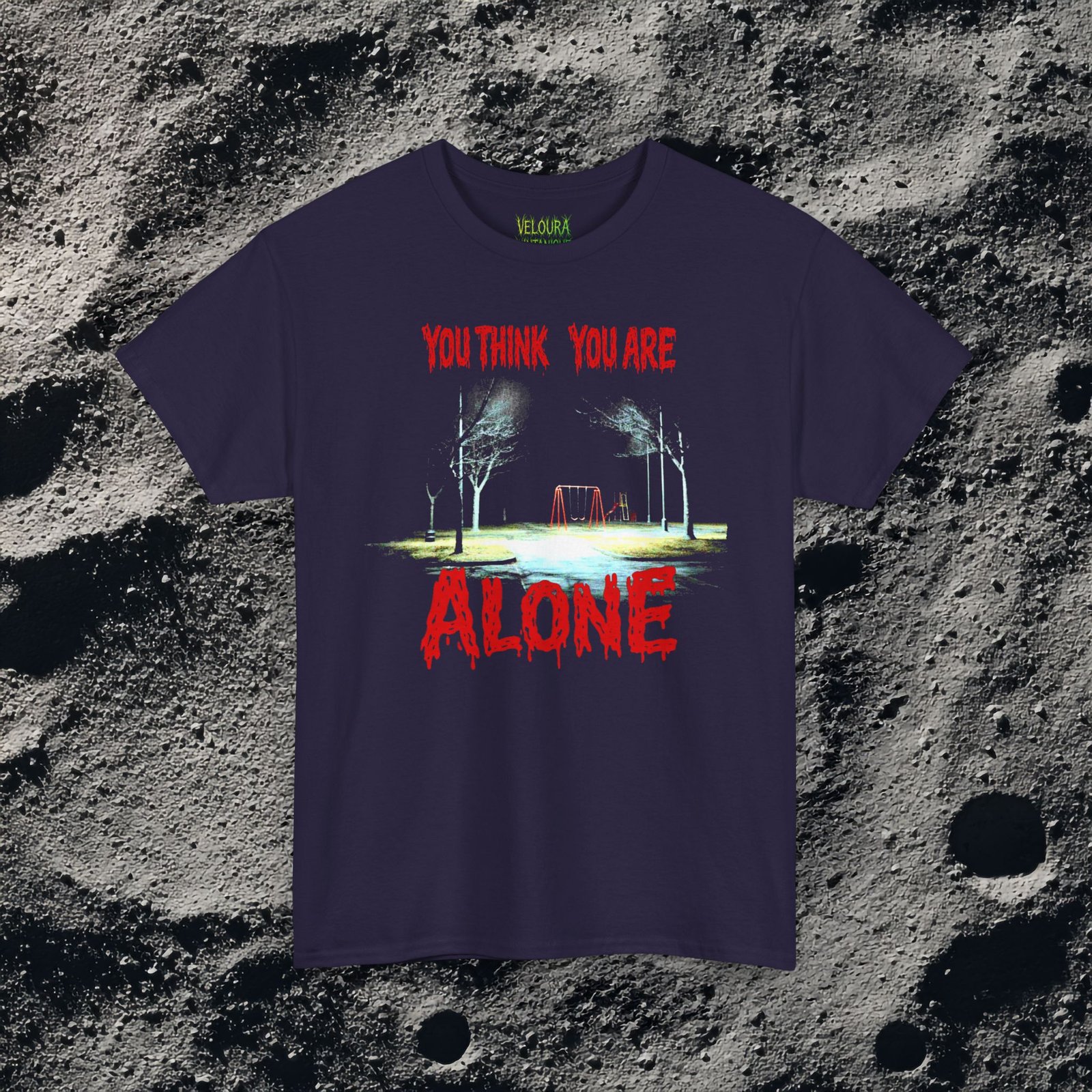 This unsettling double-sided design features a dark, rainy playground at night on the front with the text “You Think You Are Alone,” and a shadowy park path on the back with glowing eyes in the distance and the words “But the Corner of Your Eye Says Otherwise.” The grainy, low-light imagery and dripping red horror typography create a strong analog horror and liminal space atmosphere. Perfect for fans of creepy quotes, psychological horror, and eerie visual storytelling.