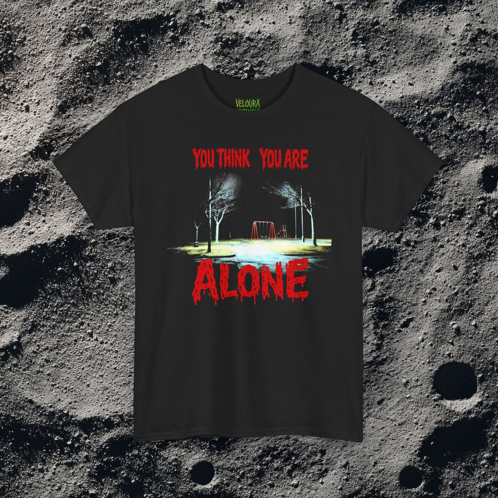 This unsettling double-sided design features a dark, rainy playground at night on the front with the text “You Think You Are Alone,” and a shadowy park path on the back with glowing eyes in the distance and the words “But the Corner of Your Eye Says Otherwise.” The grainy, low-light imagery and dripping red horror typography create a strong analog horror and liminal space atmosphere. Perfect for fans of creepy quotes, psychological horror, and eerie visual storytelling.