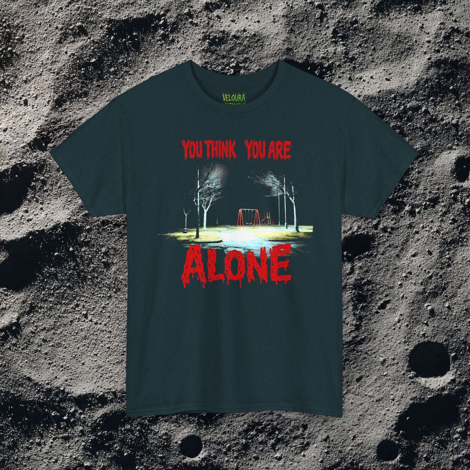 This unsettling double-sided design features a dark, rainy playground at night on the front with the text “You Think You Are Alone,” and a shadowy park path on the back with glowing eyes in the distance and the words “But the Corner of Your Eye Says Otherwise.” The grainy, low-light imagery and dripping red horror typography create a strong analog horror and liminal space atmosphere. Perfect for fans of creepy quotes, psychological horror, and eerie visual storytelling.