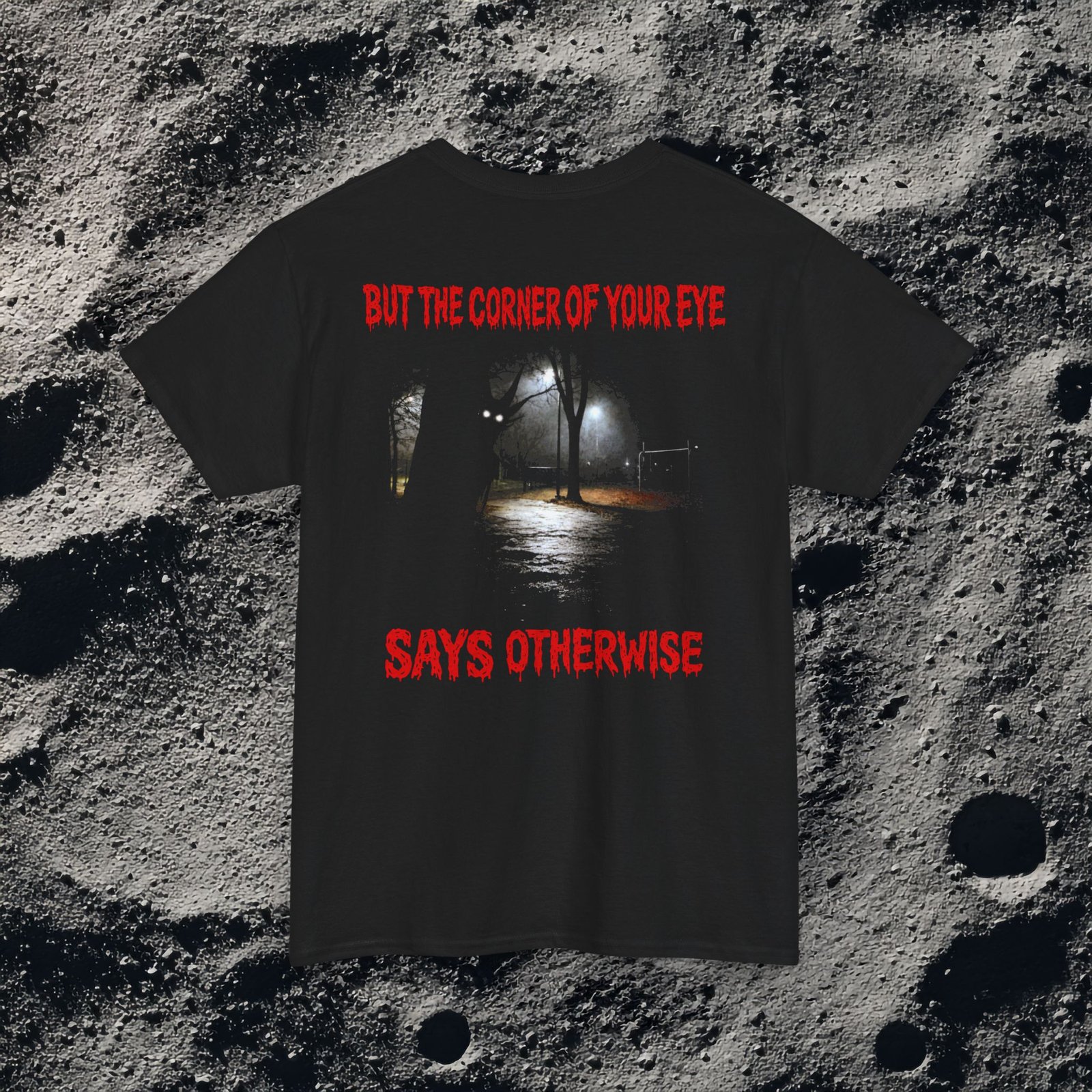 This unsettling double-sided design features a dark, rainy playground at night on the front with the text “You Think You Are Alone,” and a shadowy park path on the back with glowing eyes in the distance and the words “But the Corner of Your Eye Says Otherwise.” The grainy, low-light imagery and dripping red horror typography create a strong analog horror and liminal space atmosphere. Perfect for fans of creepy quotes, psychological horror, and eerie visual storytelling.