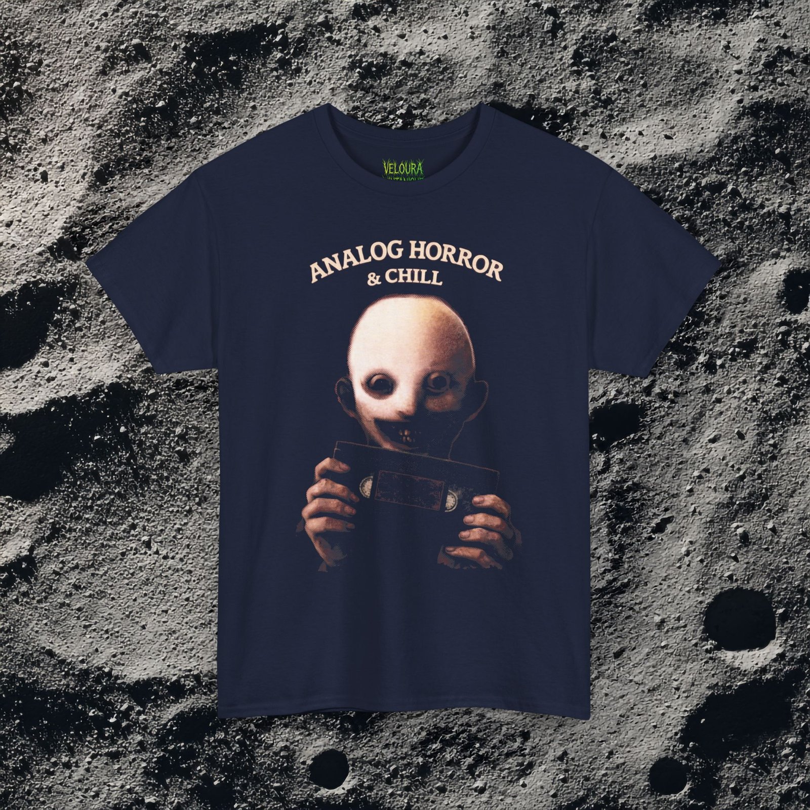 This eerie design features a pale, unsettling figure holding a VHS cassette, paired with the phrase “Analog Horror & Chill.” The dark lighting, grainy textures, and muted tones create a strong analog horror and retro found-footage aesthetic. The character’s hollow eyes and subtle smile add an extra layer of psychological unease, making this design perfect for fans of creepy visuals, weirdcore art, and retro horror culture. A must-have for anyone who loves horror with nostalgic VHS vibes.