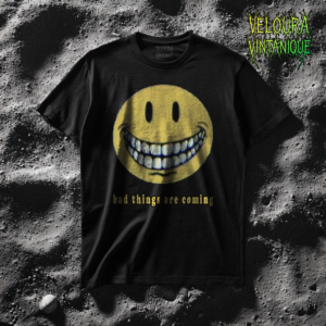 This unsettling T-shirt features a distorted yellow smiley face with an unnaturally wide grin and hollow black eyes, creating an eerie and uncanny expression. Beneath the face, the phrase “bad things are coming” adds a chilling, ominous tone. The design blends horror aesthetics with surreal meme energy, making it perfect for fans of creepy art, weirdcore, liminal visuals, and dark humor. The grainy, analog-style texture enhances the unsettling atmosphere, making this shirt a bold statement piece for anyone who loves unsettling and mysterious visuals.