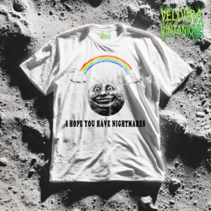 This horror graphic T-shirt features a disturbingly smiling vintage-style moon face floating beneath a bright rainbow and soft clouds. The unsettling black-and-white illustration contrasts sharply with the colorful rainbow above, while the bold text reads: “I Hope You Have Nightmares.” The design blends creepy surreal art, dark humor, and cursed meme aesthetics. Perfect for fans of horror streetwear, gothic fashion, edgy graphic tees, and ironic nightmare-core apparel.