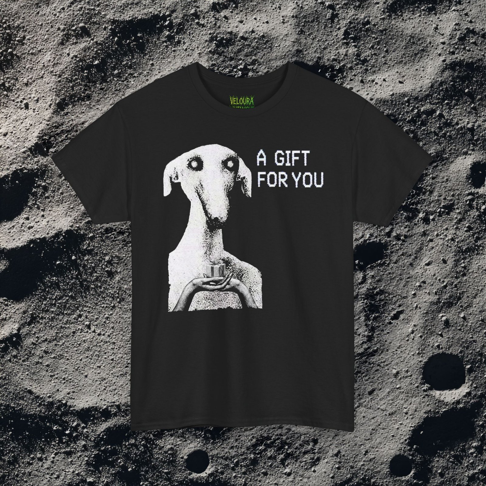 This unsettling horror T-shirt features a strange, eerie dog-like creature with hollow eyes and an unnatural expression, holding a small gift box in its hands. The grainy black-and-white texture creates a disturbing analog horror aesthetic reminiscent of cursed TV broadcasts and creepypasta imagery. The phrase “A GIFT FOR YOU” appears beside the figure in glitch-style typography, adding a mysterious and ominous tone. Perfect for fans of analog horror, creepy art, and dark streetwear.
