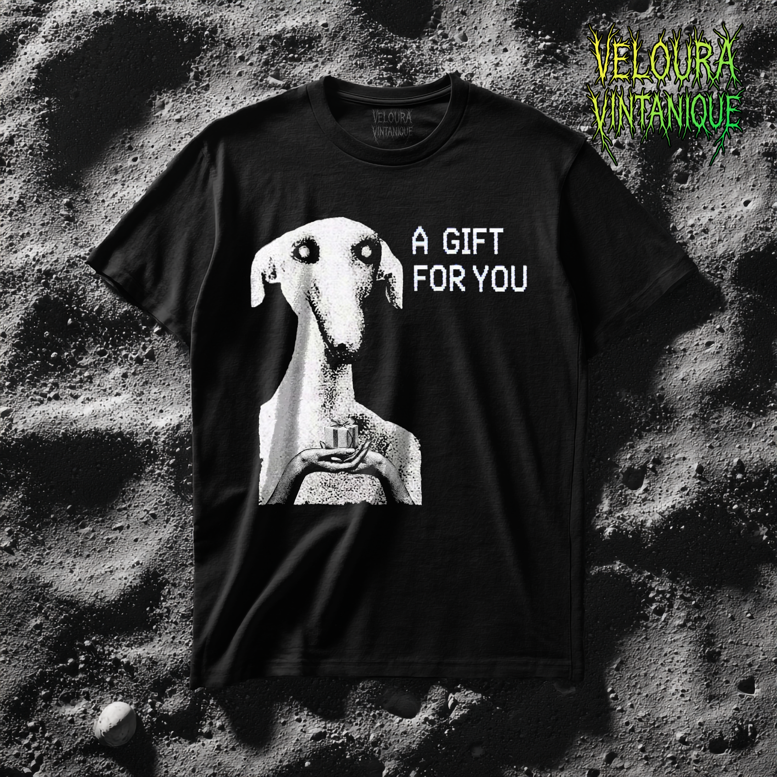 This unsettling horror T-shirt features a strange, eerie dog-like creature with hollow eyes and an unnatural expression, holding a small gift box in its hands. The grainy black-and-white texture creates a disturbing analog horror aesthetic reminiscent of cursed TV broadcasts and creepypasta imagery. The phrase “A GIFT FOR YOU” appears beside the figure in glitch-style typography, adding a mysterious and ominous tone. Perfect for fans of analog horror, creepy art, and dark streetwear.
