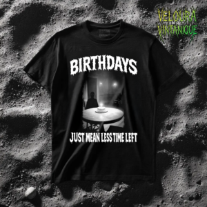 This eerie T-shirt features a haunting black-and-white scene of a dimly lit room where a lone figure sits at a table with a single birthday cake candle glowing in the darkness. The unsettling atmosphere is framed by bold horror-style typography reading “BIRTHDAYS” at the top and “JUST MEAN LESS TIME LEFT” at the bottom. The grainy analog aesthetic creates a disturbing psychological horror vibe inspired by liminal spaces and creepy late-night imagery.