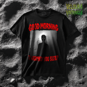 This chilling horror T-shirt features a shadowy humanoid figure standing in a dim doorway with glowing white eyes staring forward. The eerie scene is framed by bold dripping red horror-style text reading “GOOD MORNING” and “I WATCHED YOU SLEEP.” The grainy black-and-white image gives the design a disturbing analog horror and found-footage aesthetic. The minimal yet unsettling composition creates an intense creepy atmosphere perfect for horror fans and dark streetwear enthusiasts.