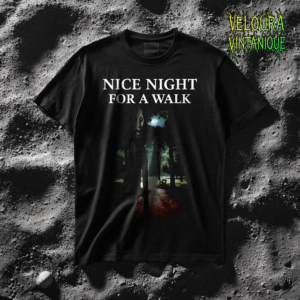This eerie horror T-shirt features a dark forest path illuminated by dim moonlight while a tall shadowy figure with an unsettling face stands in the foreground. The mysterious character appears partially hidden in the darkness, giving the scene a disturbing stalker-like presence. Above the image, the text “Nice Night For a Walk” contrasts with the sinister atmosphere. The design has a cinematic analog horror style with deep shadows, glowing highlights, and a haunting outdoor setting.