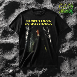 This chilling horror design features the phrase “SOMETHING IS WATCHING” in bold yellow lettering above a dark forest scene. Between pale, leafless trees stands a shadowy humanoid figure with glowing eyes and a terrifying, sharp-toothed grin. The grainy texture and muted colors create an eerie analog horror atmosphere, resembling a distorted photograph or found footage. The contrast between the quiet forest and the lurking figure builds tension, making this design perfect for fans of creepy, unsettling, and psychological horror visuals.
